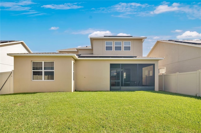 1564 Atlantic Coastline Loop, Oakland, FL 34787 - rear view of house with a sunroom, solar panels, a fenced backyard, and stucco siding