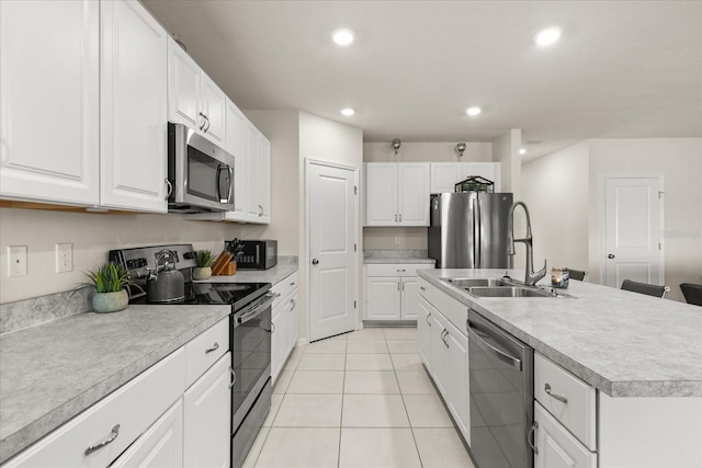 384 Quarry Rock Cir, Kissimmee, FL 34758 - kitchen with stainless steel appliances, light countertops, light tile patterned floors, recessed lighting, and white cabinets