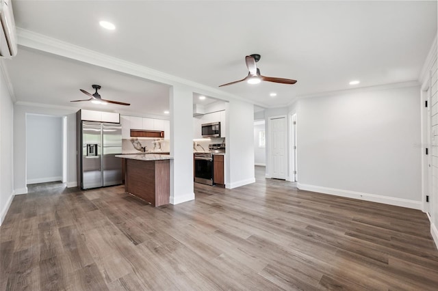 4505 Cottonwood Dr, New Port Richey, FL 34652 - kitchen with stainless steel appliances, ceiling fan, white cabinets, open floor plan, and recessed lighting
