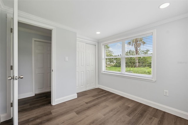 4505 Cottonwood Dr, New Port Richey, FL 34652 - unfurnished bedroom featuring dark wood finished floors, ornamental molding, recessed lighting, and a closet