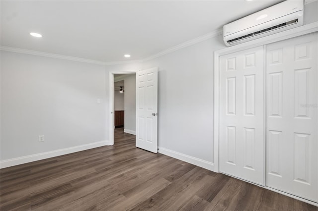 4505 Cottonwood Dr, New Port Richey, FL 34652 - unfurnished bedroom with an AC wall unit, dark wood-type flooring, ornamental molding, recessed lighting, and a closet