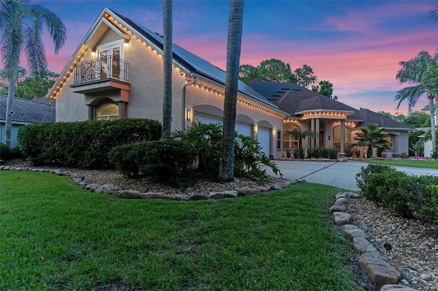 32 Allenwood Look, Ormond Beach, FL 32174 - mediterranean / spanish-style home with a balcony, stucco siding, an attached garage, and a yard