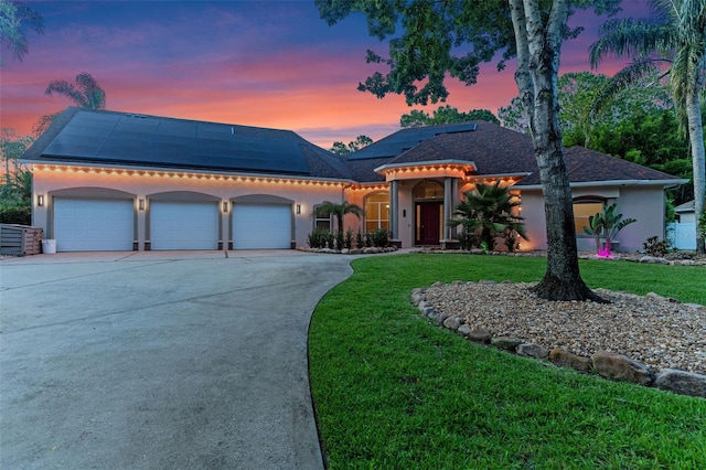 32 Allenwood Look, Ormond Beach, FL 32174 - view of front of property featuring stucco siding, a front yard, a garage, concrete driveway, and solar panels