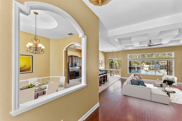 32 Allenwood Look, Ormond Beach, FL 32174 - living area with wood finished floors, arched walkways, coffered ceiling, a ceiling fan, and a chandelier