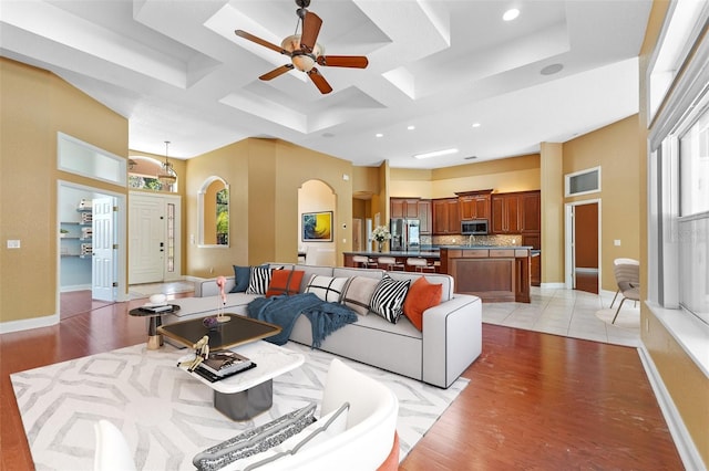 32 Allenwood Look, Ormond Beach, FL 32174 - living room featuring coffered ceiling, ceiling fan, light wood-style flooring, recessed lighting, and arched walkways