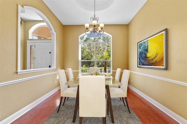 32 Allenwood Look, Ormond Beach, FL 32174 - dining space featuring wood finished floors, a chandelier, and a textured wall