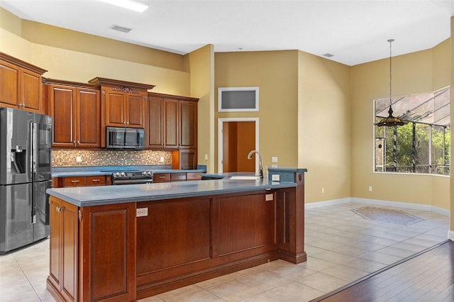 32 Allenwood Look, Ormond Beach, FL 32174 - kitchen with stainless steel appliances, tasteful backsplash, dark countertops, decorative light fixtures, and brown cabinets