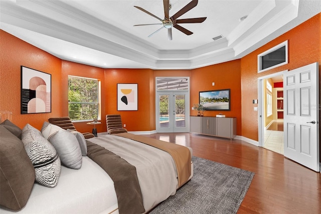 32 Allenwood Look, Ormond Beach, FL 32174 - bedroom featuring a raised ceiling, ornamental molding, access to exterior, wood finished floors, and french doors