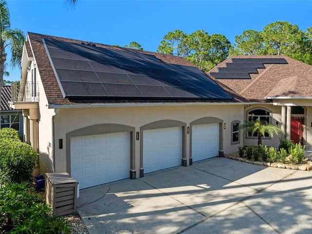 32 Allenwood Look, Ormond Beach, FL 32174 - view of front of property with roof with shingles, roof mounted solar panels, stucco siding, and driveway
