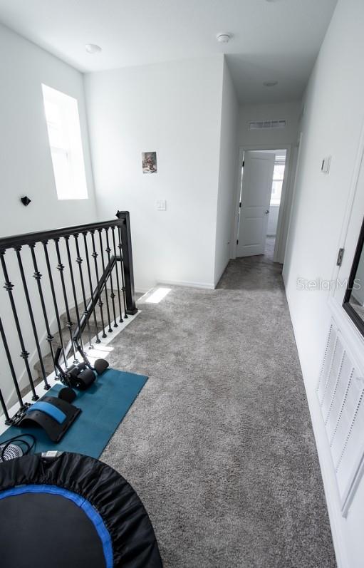 4152 Pino St, Apopka, FL 32712 - hall featuring carpet floors and an upstairs landing
