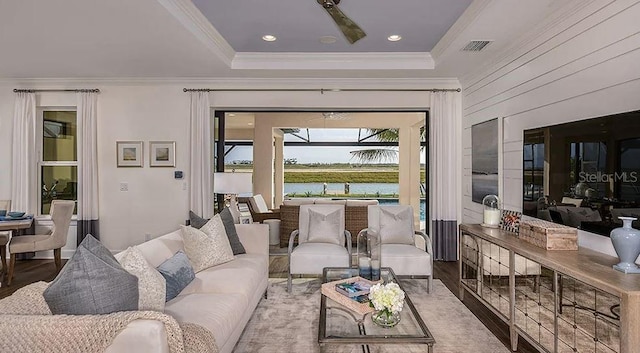 858 Arbor Green Trl, Saint Cloud, FL 34771 - living room with crown molding, wood finished floors, a water view, and a raised ceiling