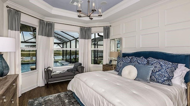 858 Arbor Green Trl, Saint Cloud, FL 34771 - bedroom featuring a chandelier, ornamental molding, dark wood-type flooring, and a tray ceiling