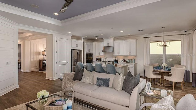 858 Arbor Green Trl, Saint Cloud, FL 34771 - living area featuring dark wood-style flooring, ornamental molding, and a chandelier