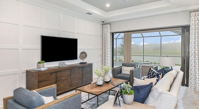 858 Arbor Green Trl, Saint Cloud, FL 34771 - living area featuring a decorative wall, a tray ceiling, and crown molding