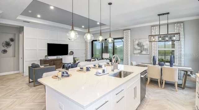858 Arbor Green Trl, Saint Cloud, FL 34771 - kitchen featuring white cabinets, dishwasher, a kitchen island with sink, ornamental molding, and hanging light fixtures