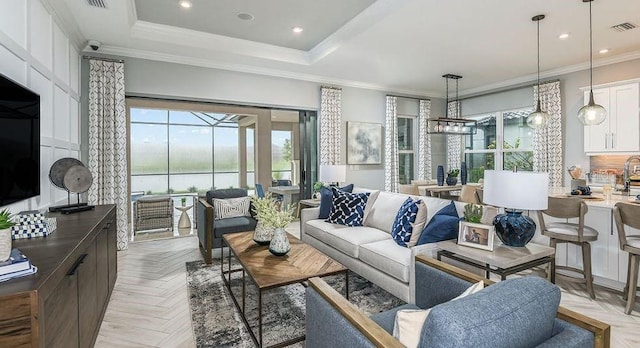 858 Arbor Green Trl, Saint Cloud, FL 34771 - living area with ornamental molding, a chandelier, recessed lighting, and a tray ceiling