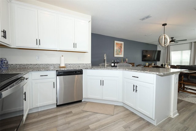 2326 Carrabelle Way, Sanford, FL 32771 - kitchen featuring dishwasher, a peninsula, range, light wood finished floors, and white cabinets