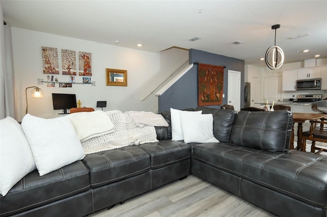 2326 Carrabelle Way, Sanford, FL 32771 - living area featuring light wood finished floors, stairway, and recessed lighting