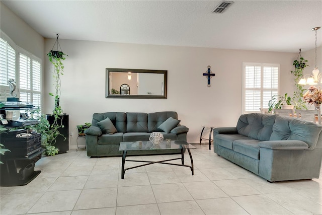 480 Kestrel Dr, Groveland, FL 34736 - living room with a chandelier and light tile patterned floors