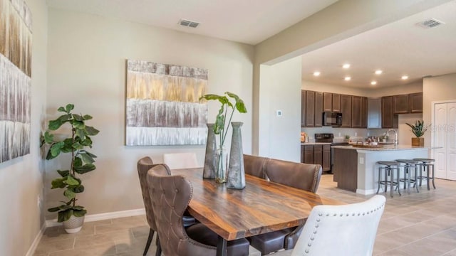 12518 Maginn Ct, Weeki Wachee, FL 34614 - dining room with recessed lighting and light tile patterned floors