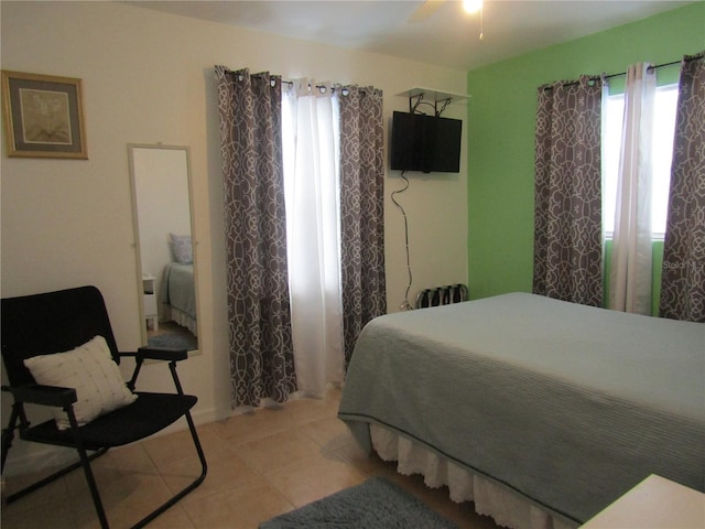 5010 Shoshone St, Orlando, FL 32819 - bedroom with light tile patterned floors and ceiling fan