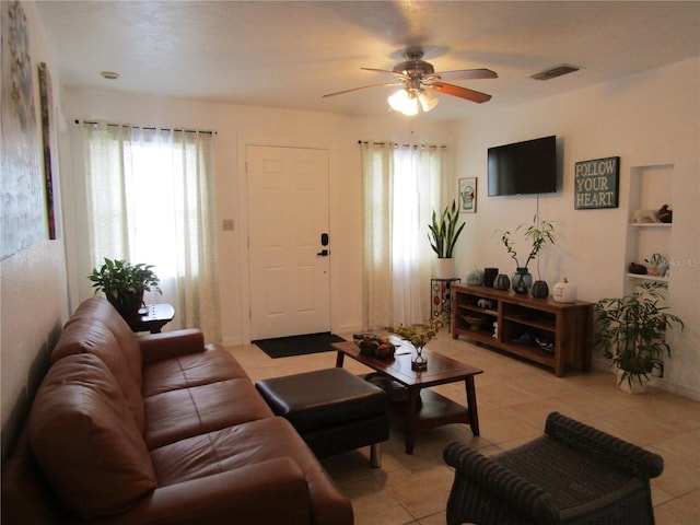 5010 Shoshone St, Orlando, FL 32819 - living area with healthy amount of natural light, a ceiling fan, and light tile patterned floors