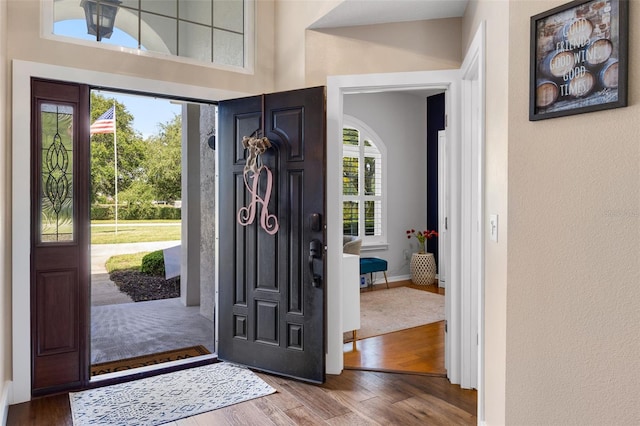 5141 Autumn Ridge Ln, Windermere, FL 34786 - entryway featuring wood finished floors, arched walkways, and a textured wall