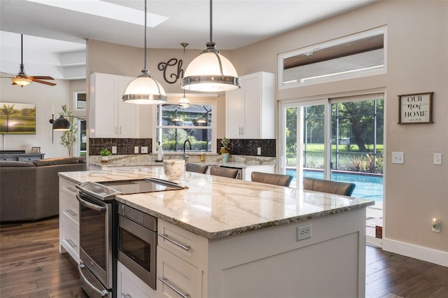 5141 Autumn Ridge Ln, Windermere, FL 34786 - kitchen with appliances with stainless steel finishes, open floor plan, backsplash, and dark wood finished floors