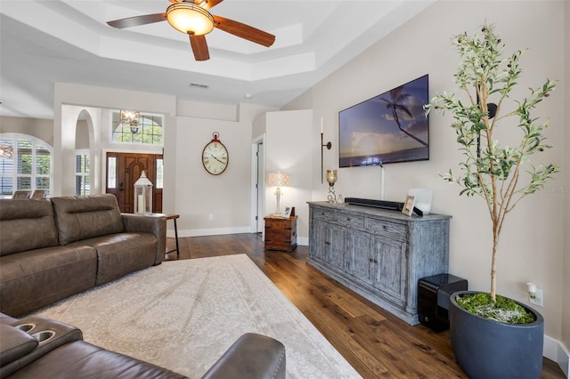 5141 Autumn Ridge Ln, Windermere, FL 34786 - living room featuring a raised ceiling, dark wood-style flooring, a ceiling fan, a chandelier, and arched walkways