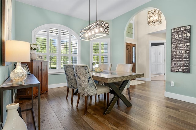 5141 Autumn Ridge Ln, Windermere, FL 34786 - dining space featuring a chandelier, dark wood-style flooring, and arched walkways