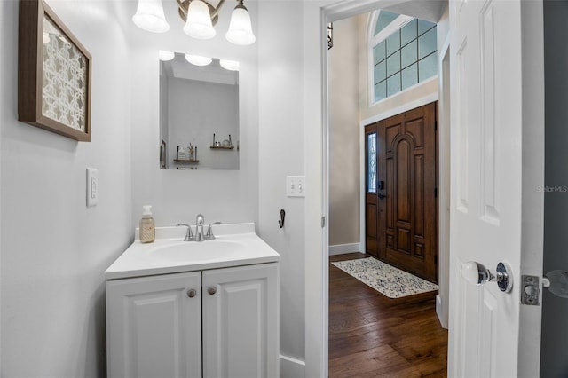 5141 Autumn Ridge Ln, Windermere, FL 34786 - bathroom featuring vanity, wood finished floors, and a chandelier