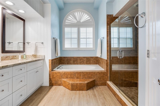 5141 Autumn Ridge Ln, Windermere, FL 34786 - bathroom featuring vanity, a garden tub, a stall shower, and wood finished floors