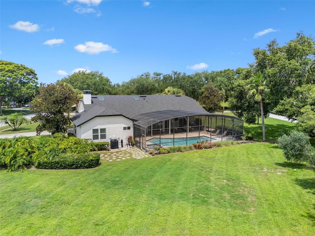 5141 Autumn Ridge Ln, Windermere, FL 34786 - back of house with an outdoor pool, a lawn, a chimney, and a lanai