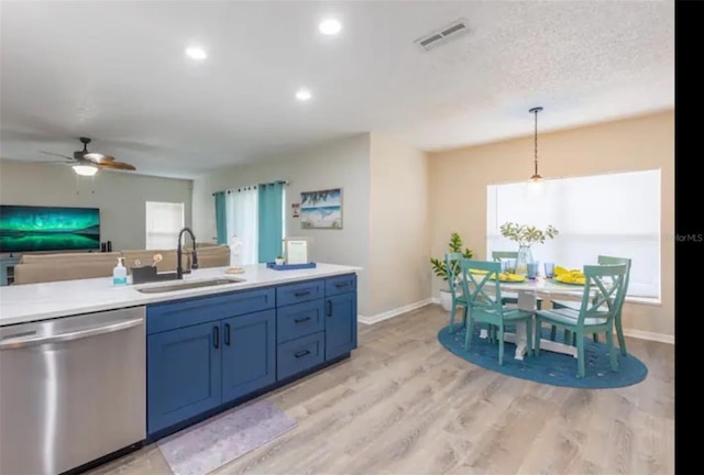 365 Aylesbury Ct, Kissimmee, FL 34758 - kitchen with stainless steel dishwasher, light wood-style flooring, ceiling fan, light countertops, and pendant lighting