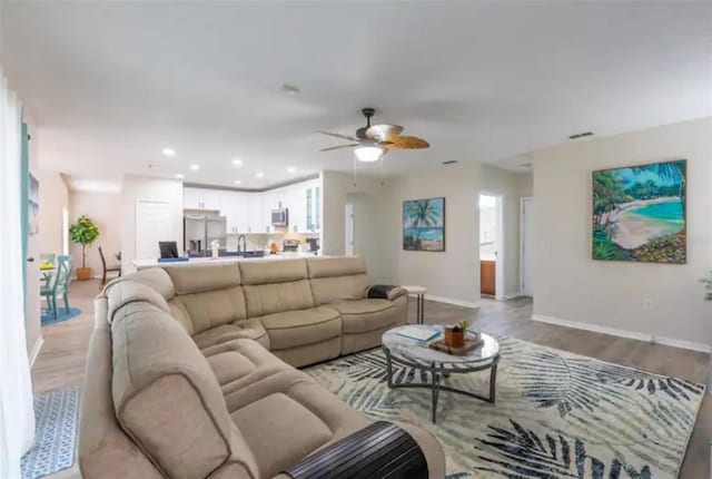365 Aylesbury Ct, Kissimmee, FL 34758 - living area featuring light wood finished floors, a ceiling fan, and recessed lighting