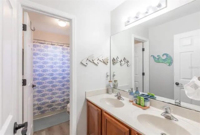 365 Aylesbury Ct, Kissimmee, FL 34758 - full bath with double vanity, a shower with shower curtain, and wood finished floors