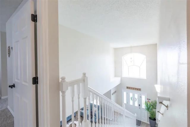 365 Aylesbury Ct, Kissimmee, FL 34758 - hall with an upstairs landing and a textured ceiling
