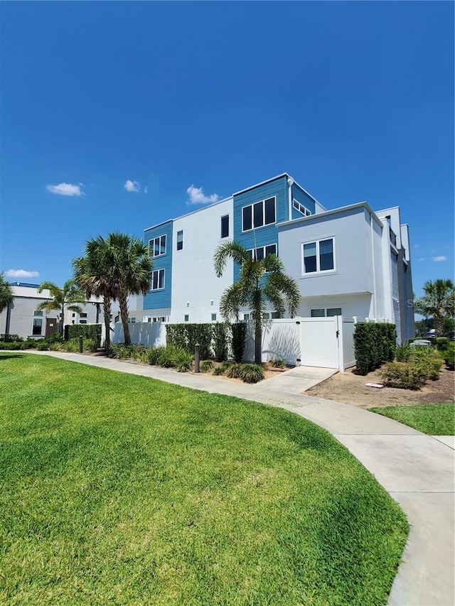 7740 Sandy Ridge Dr Unit 102, Reunion, FL 34747 - view of front of house featuring stucco siding and a gate