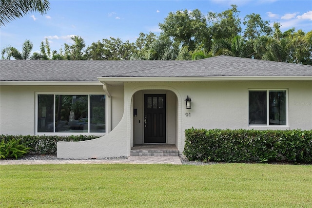 91 Minnehaha Cir, Maitland, FL 32751 - view of front of house featuring a front yard, stucco siding, and roof with shingles