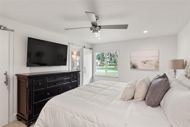 91 Minnehaha Cir, Maitland, FL 32751 - bedroom featuring recessed lighting, a barn door, a ceiling fan, a textured ceiling, and ensuite bath