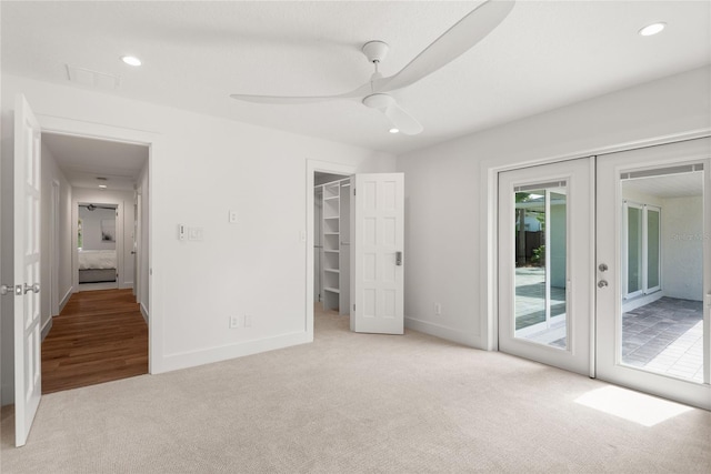 91 Minnehaha Cir, Maitland, FL 32751 - unfurnished bedroom with carpet floors, access to exterior, french doors, a spacious closet, and a ceiling fan
