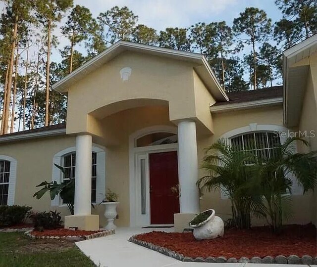 37 Ethan Allen Dr, Palm Coast, FL 32164 - view of exterior entry with stucco siding