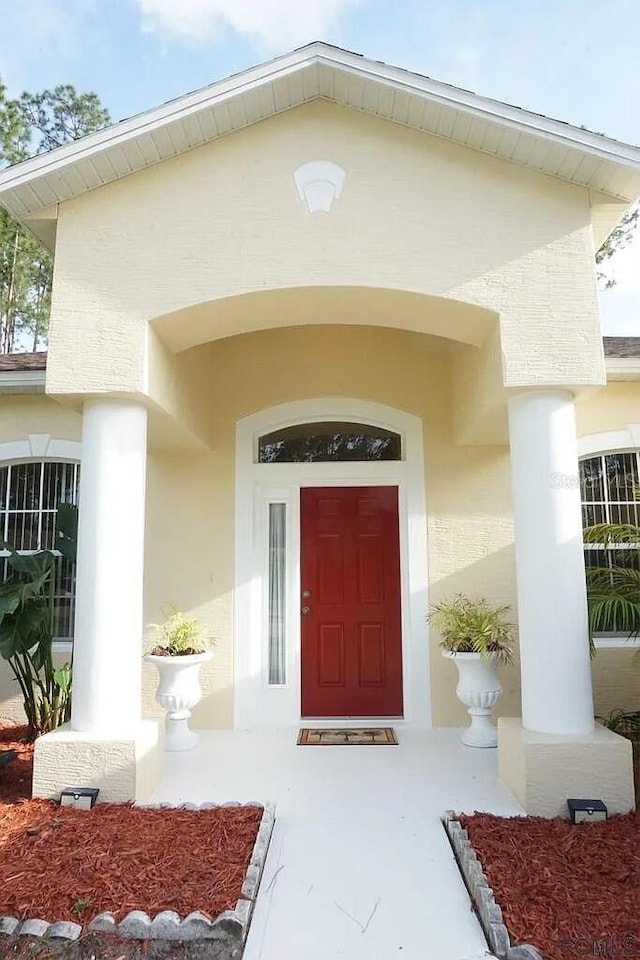 37 Ethan Allen Dr, Palm Coast, FL 32164 - property entrance featuring stucco siding