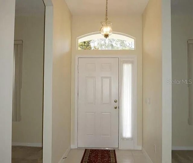 37 Ethan Allen Dr, Palm Coast, FL 32164 - entrance foyer featuring arched walkways, light tile patterned flooring, and a chandelier