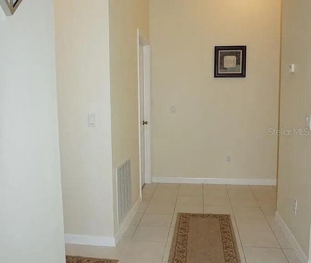37 Ethan Allen Dr, Palm Coast, FL 32164 - corridor featuring baseboards and light tile patterned floors