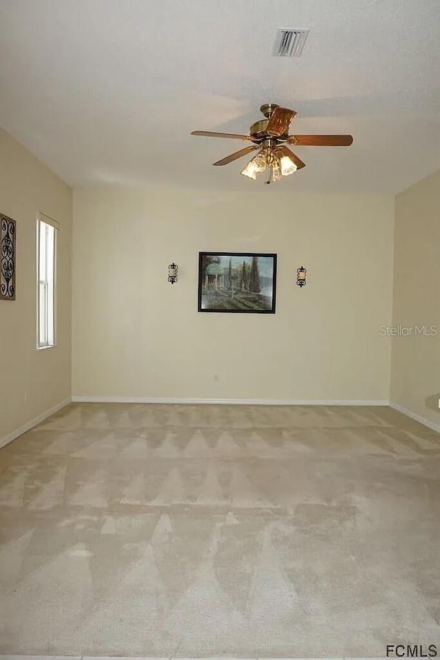 37 Ethan Allen Dr, Palm Coast, FL 32164 - unfurnished room with light colored carpet and a ceiling fan