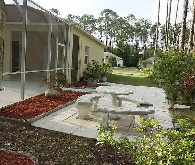 37 Ethan Allen Dr, Palm Coast, FL 32164 - view of yard with a patio and glass enclosure