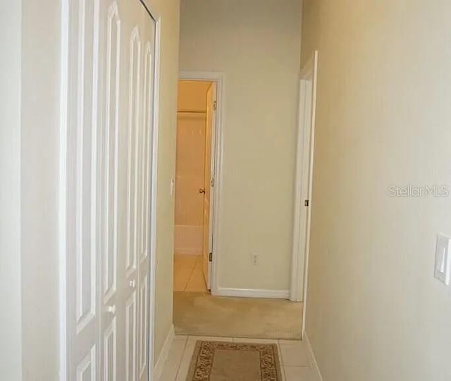 37 Ethan Allen Dr, Palm Coast, FL 32164 - hallway with tile patterned flooring and baseboards