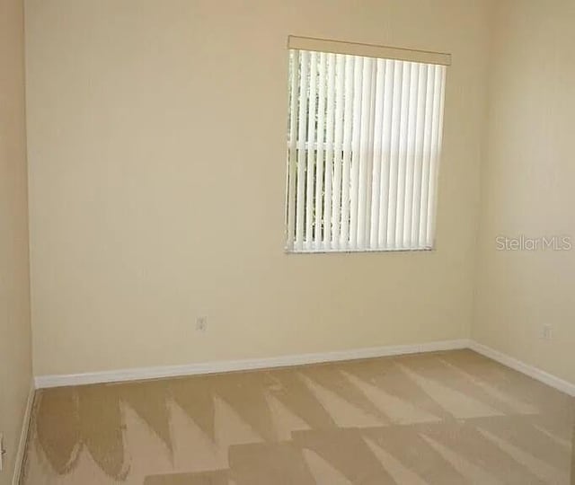 37 Ethan Allen Dr, Palm Coast, FL 32164 - carpeted empty room featuring baseboards