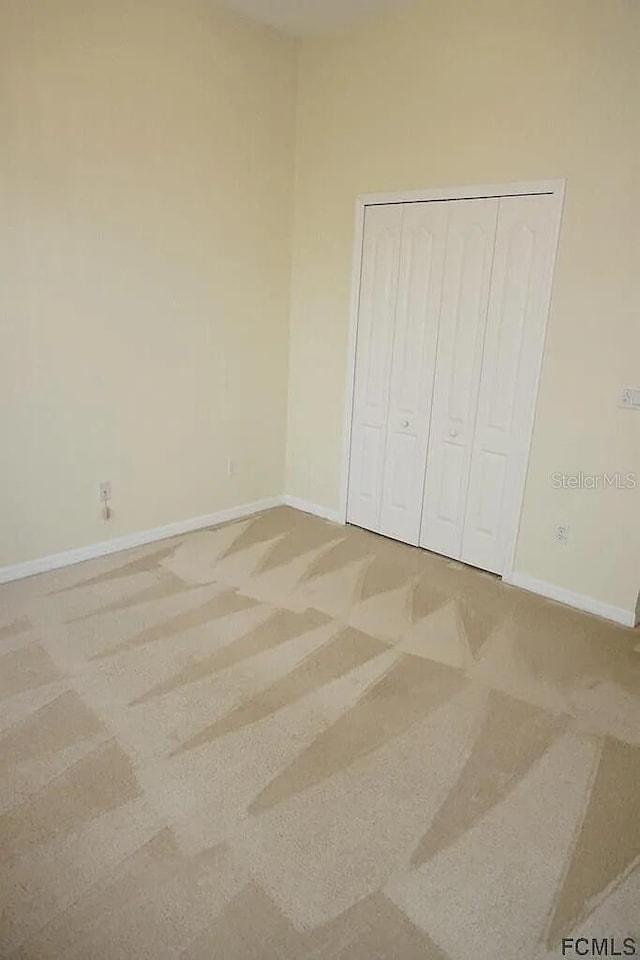 37 Ethan Allen Dr, Palm Coast, FL 32164 - unfurnished bedroom with a closet and carpet flooring
